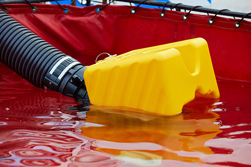 A close up of a yellow floating strainer from TFT in a red dump tank