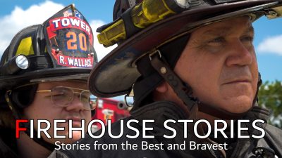 Firehouse Stories: How Fog Patterns Save Lives - text sits over the background. Two firefighters stand next to eachother under a blue sky.