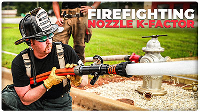 a Firefighter sprays water from a Metro Nozzle representing the K Factor of a nozzle