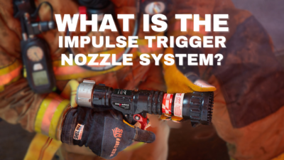 A firefighter holds a nozzle with the impulse trigger nozzle system.