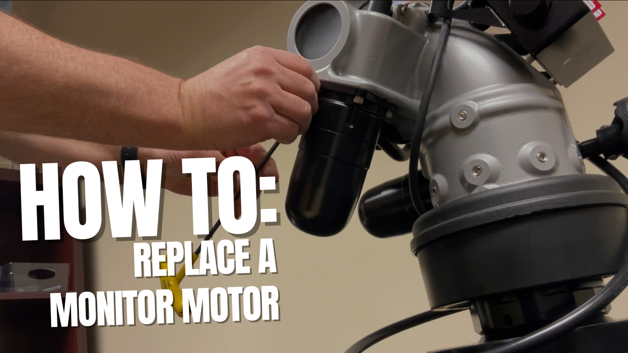 A hand reaches toward the motor of a TFT firefighting Monitor during a tft monitor motor replacement